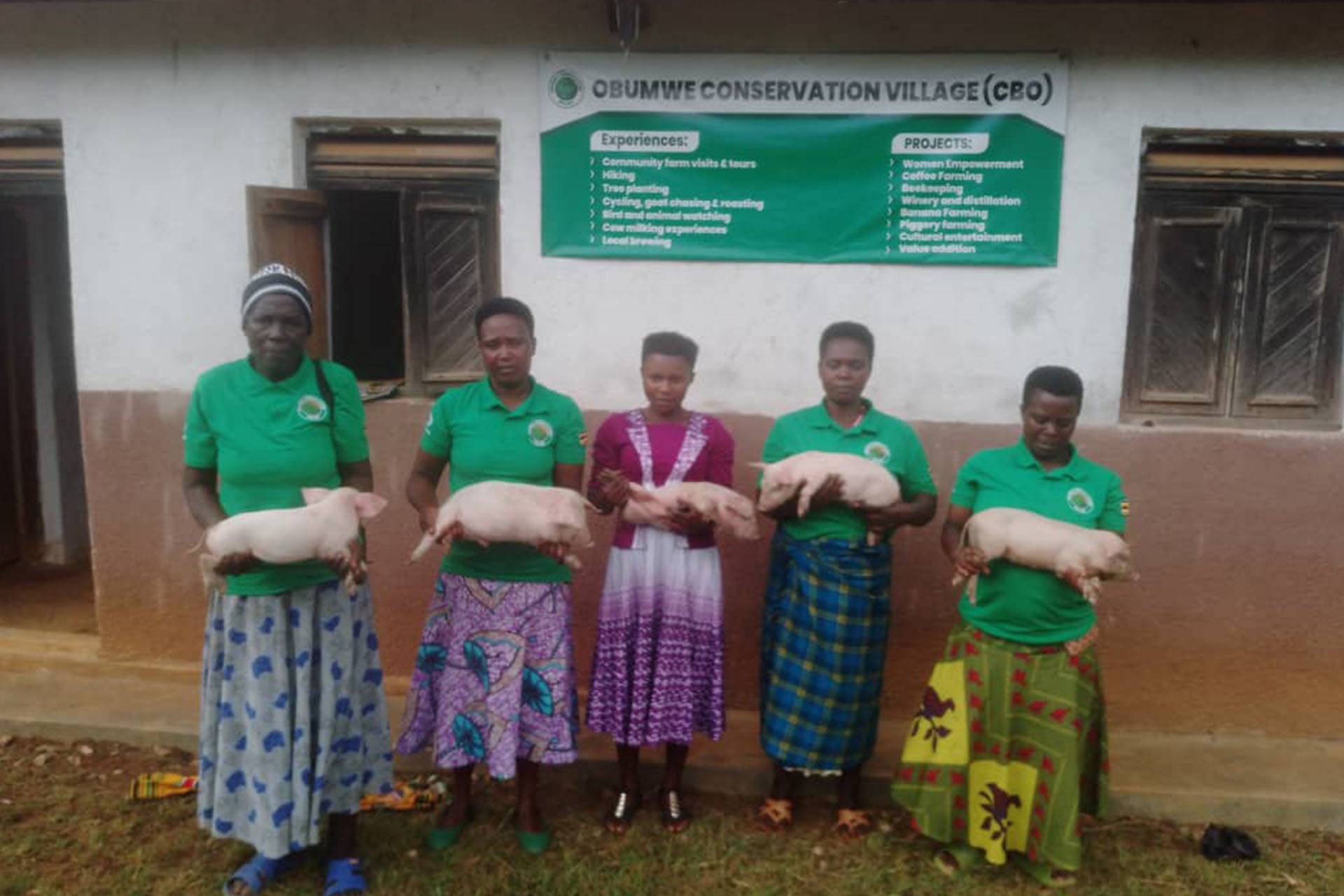 Obumwe Conservation Village women receiving piglets for economical empowerment